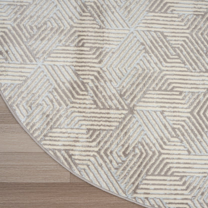 Round area rug with geometric interlocking line pattern in beige & gray on light wood floor.