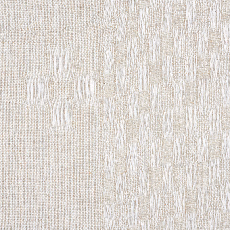 Cream two-tone woven fabric swatch with smooth left half and raised geometric pattern on the right.