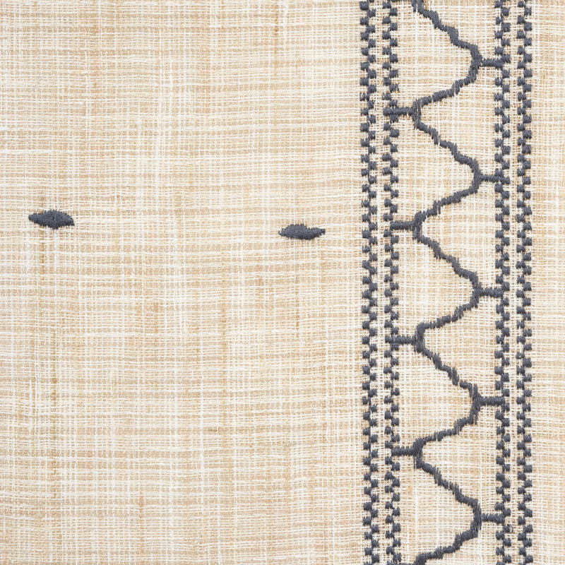 Beige woven textile with navy & zigzag border on the right and small navy knots; rustic decorative fabric.