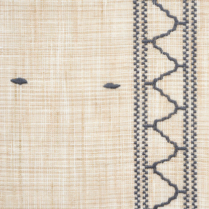 Beige woven textile with navy & zigzag border on the right and small navy knots; rustic decorative fabric.