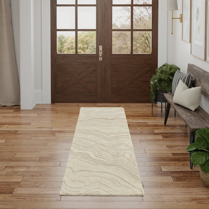 Cream beige hallway runner rug with a subtle wavy pattern on a hardwood floor in an entryway with a bench and potted plants.
