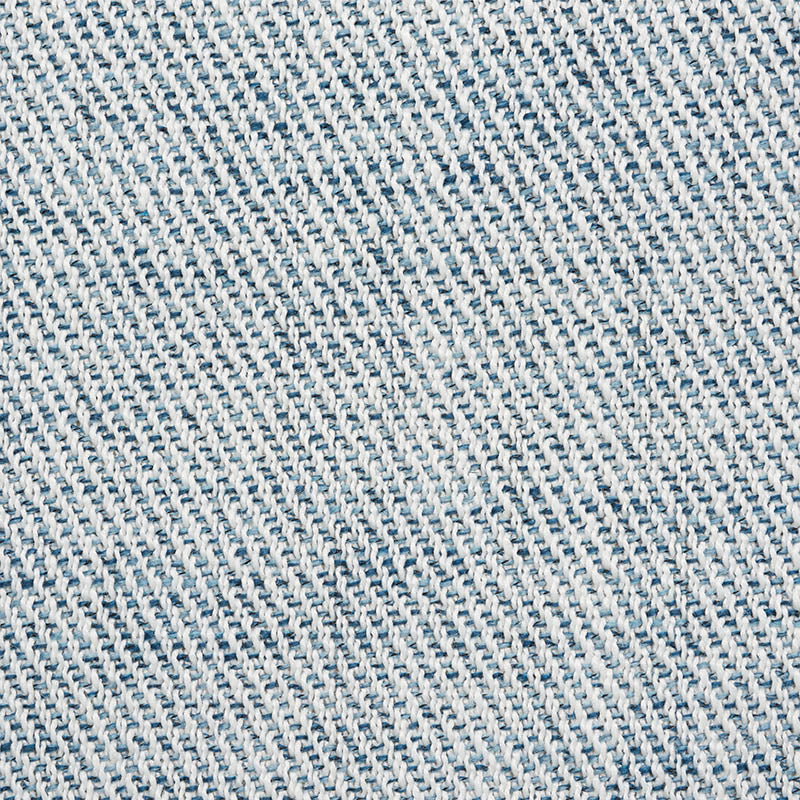 Light blue denim fabric close-up with diagonal twill weave; cotton jean material for casual wear.
