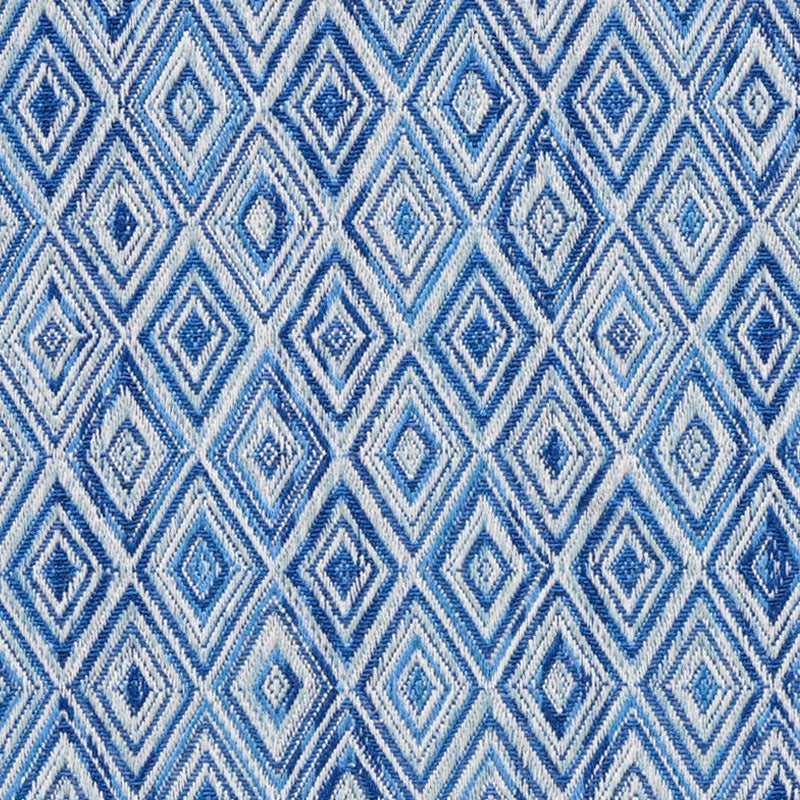 Woven textile featuring a repeating blue diamond lattice in light and dark blue tones, decorative geometric pattern.