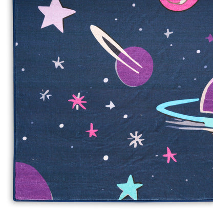 Dark blue area rug with a space pattern featuring rings, stars, and colorful planets in pink, purple, teal.