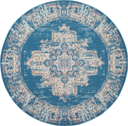 Round blue rug with cream distressed Persian medallion pattern and decorative border, vintage-style floor decor.