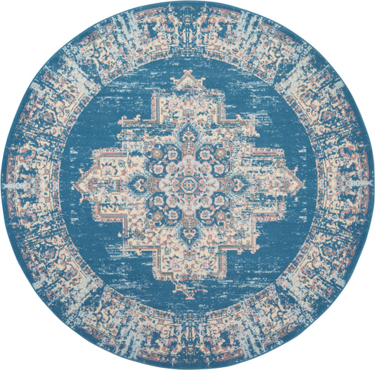 Round blue rug with cream distressed Persian medallion pattern and decorative border, vintage-style floor decor.