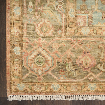 Close-up of fringed oriental vintage rug with brown border and muted geometric patterns in beige, teal, pink, and olive, 9' x 12'.