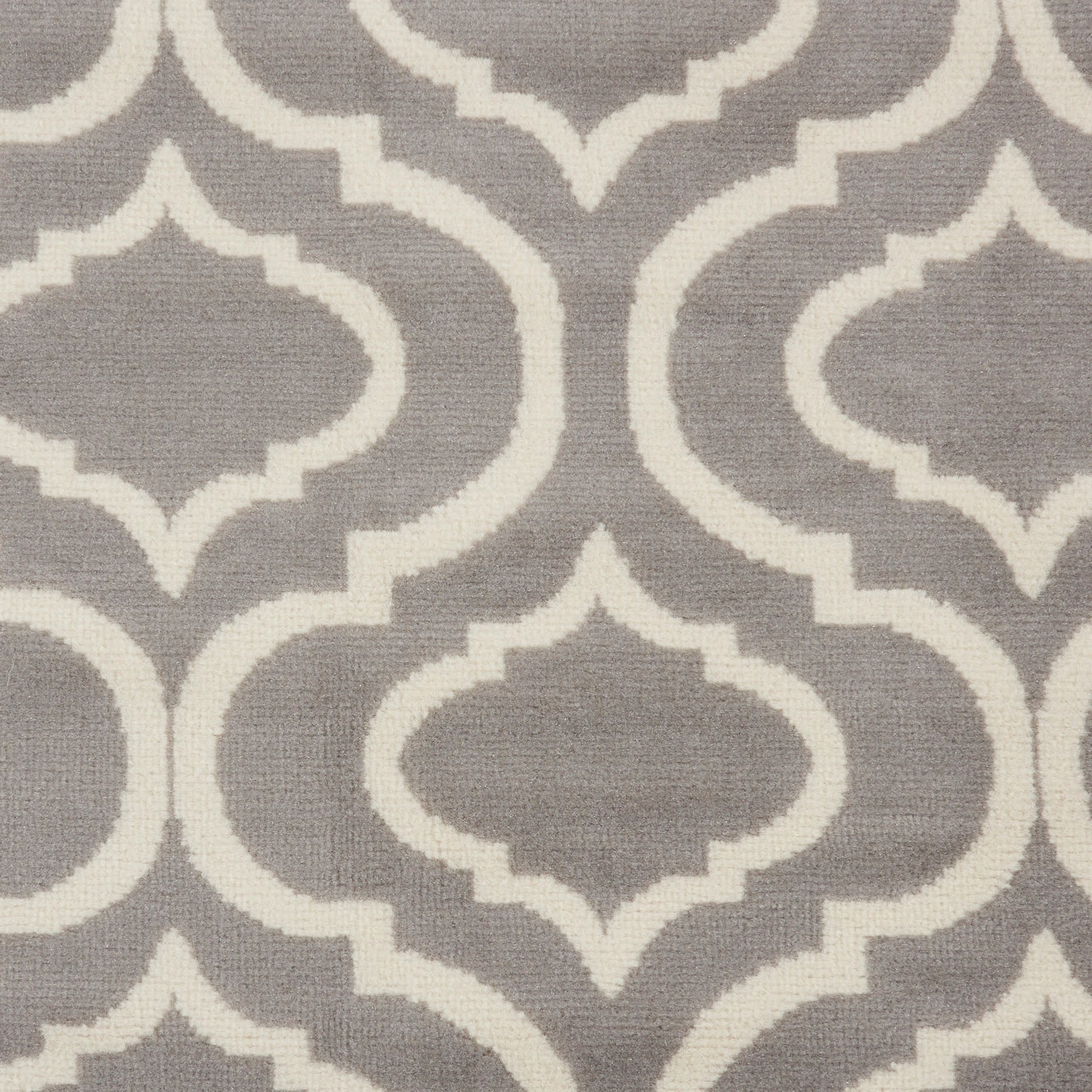 Gray rug with a white interlocking Moroccan trellis pattern; soft woven texture.