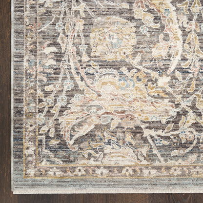 Traditional gray area rug with ivory, pale blue and beige floral medallion pattern and decorative border on dark wood floor.