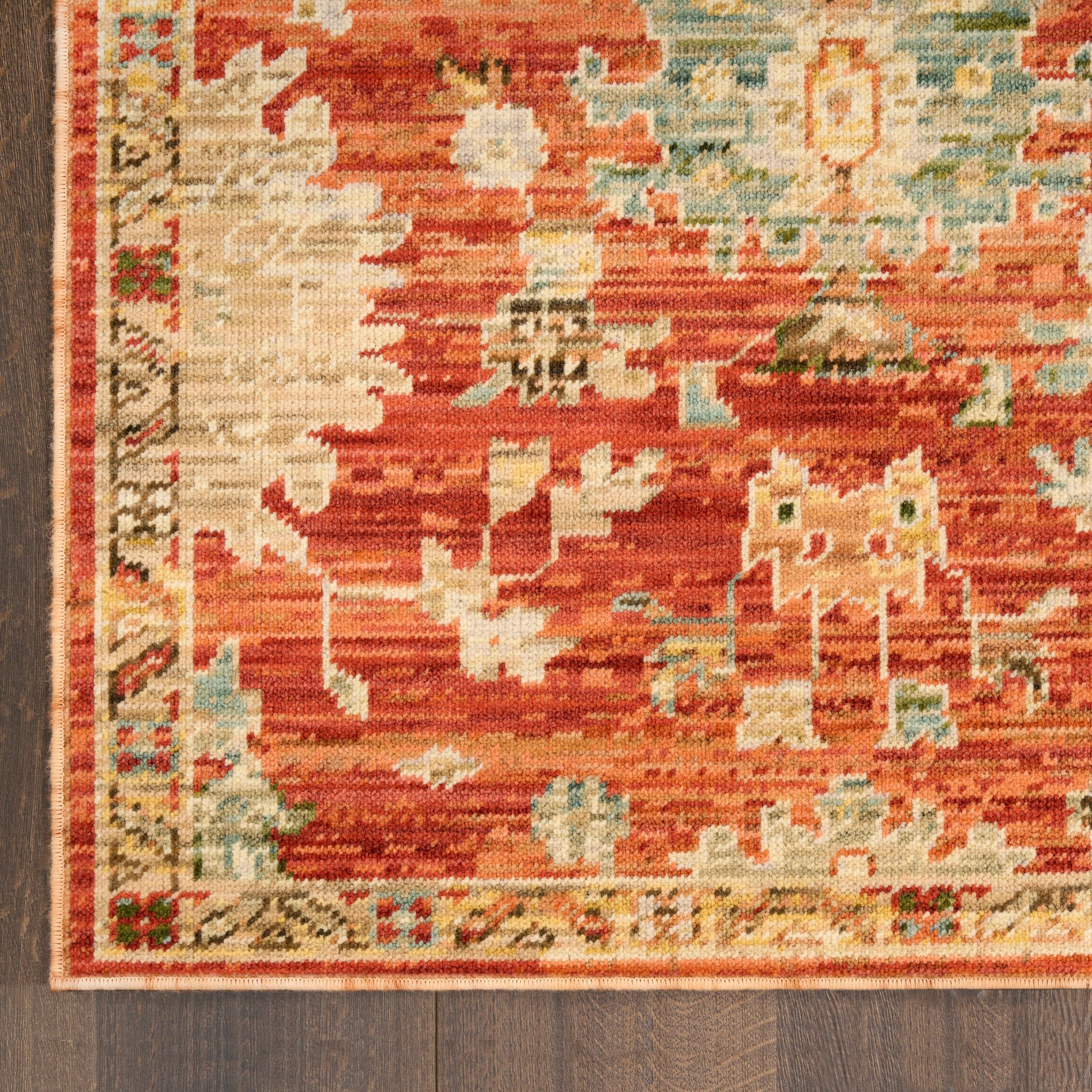 Rust-red oriental runner rug with cream-blue geometric motifs and a decorative border on a dark wood floor