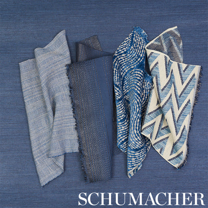 Blue fabric swatches in varied textures and patterns: stripes, dots, chevrons, waves on blue backdrop.