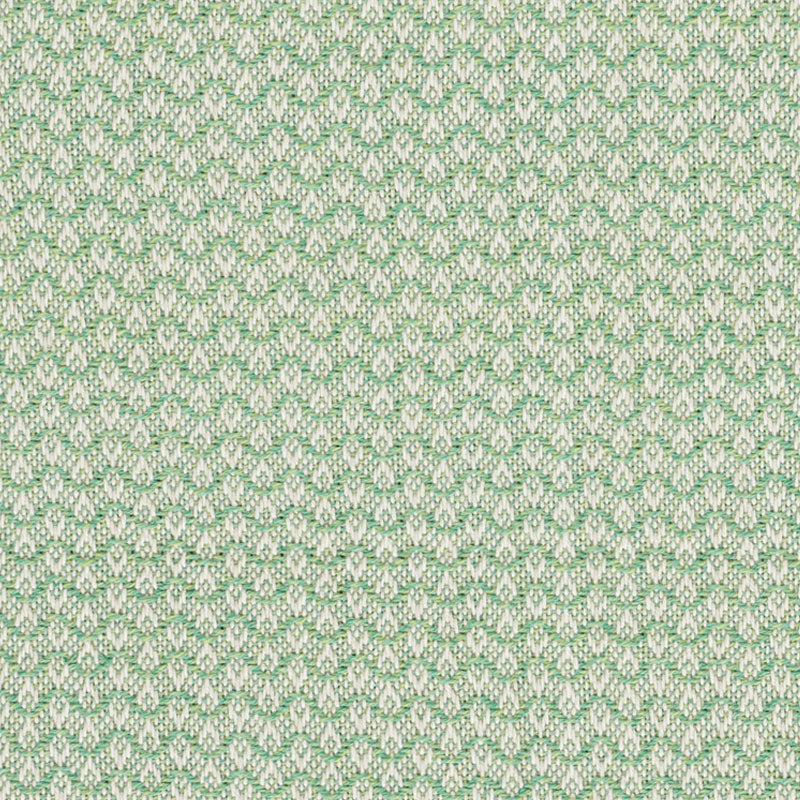 Close-up of pastel green and beige jacquard fabric with tiny repeating leaf motif; textured upholstery textile.