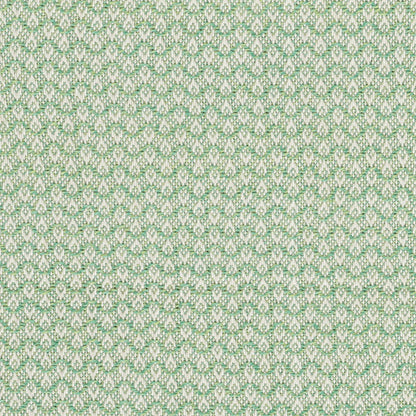 Close-up of pastel green and beige jacquard fabric with tiny repeating leaf motif; textured upholstery textile.