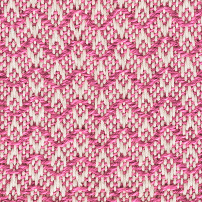 Close-up of magenta and cream woven fabric with zigzag chevron pattern, textured cotton-like textile.