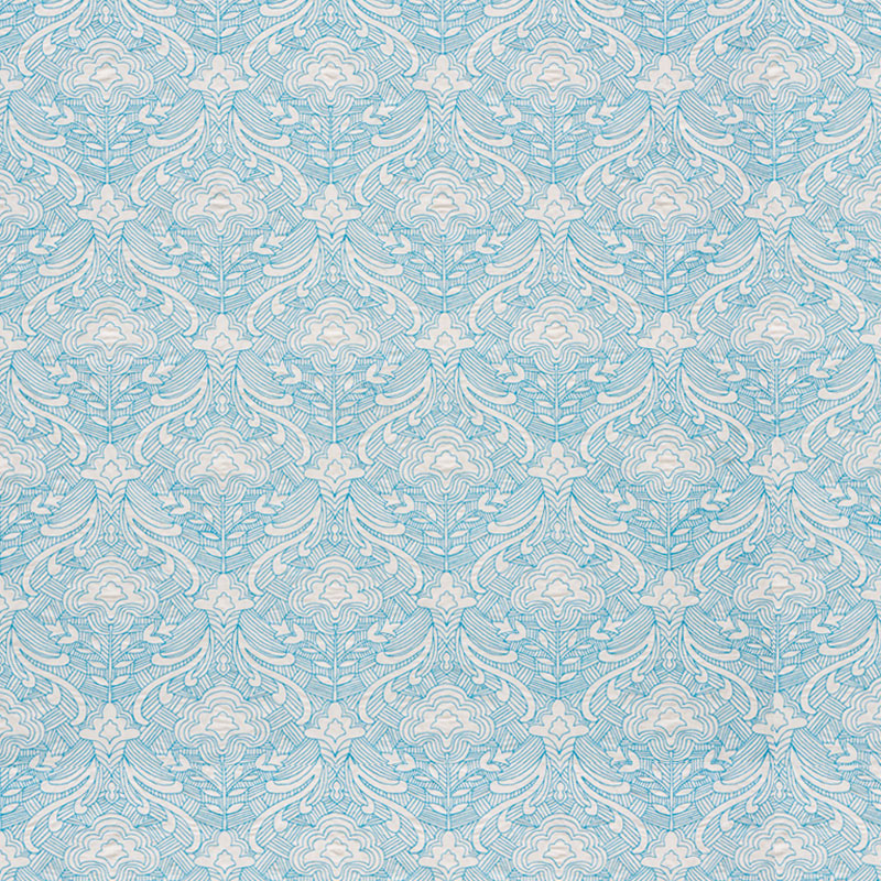 Blue embroidered woven fabric with ornate white scrollwork and leafy floral motifs.