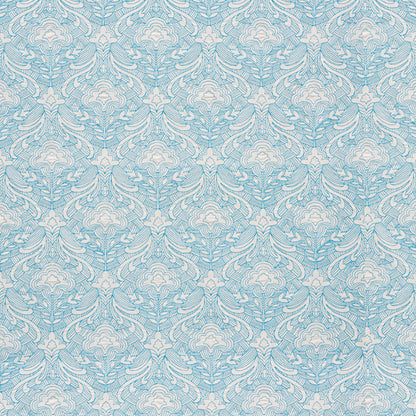 Blue embroidered woven fabric with ornate white scrollwork and leafy floral motifs.