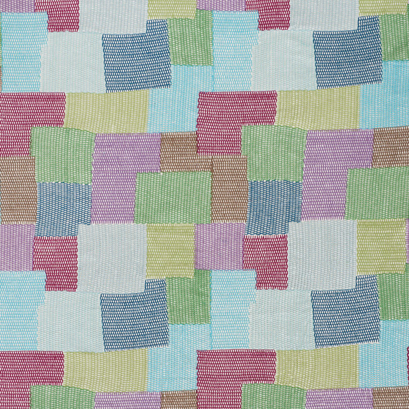 Pastel patchwork fabric with stitched squares in blue, pink, green, yellow and lavender; soft woven textile pattern.