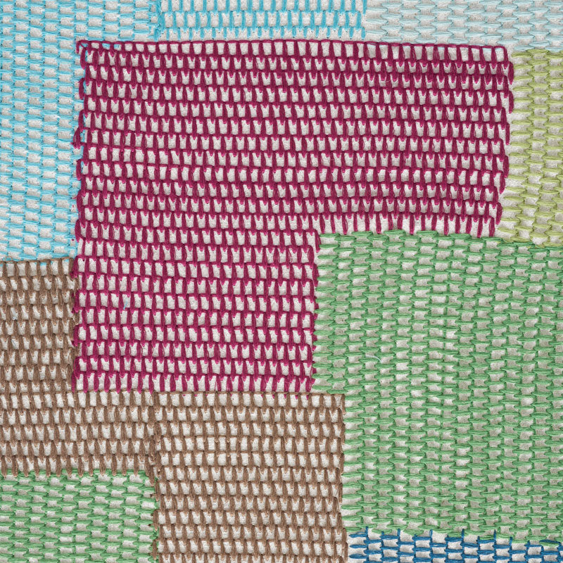 Embroidered patchwork textile with multicolor rectangular blocks in blue, green, pink, brown and cream.