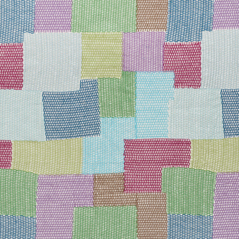 Pastel patchwork fabric squares in woven texture, quilt-style mosaic in blues, pinks, greens, yellows and lilacs.