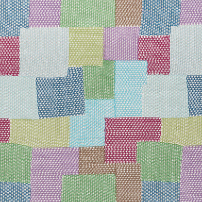 Pastel patchwork fabric squares in woven texture, quilt-style mosaic in blues, pinks, greens, yellows and lilacs.