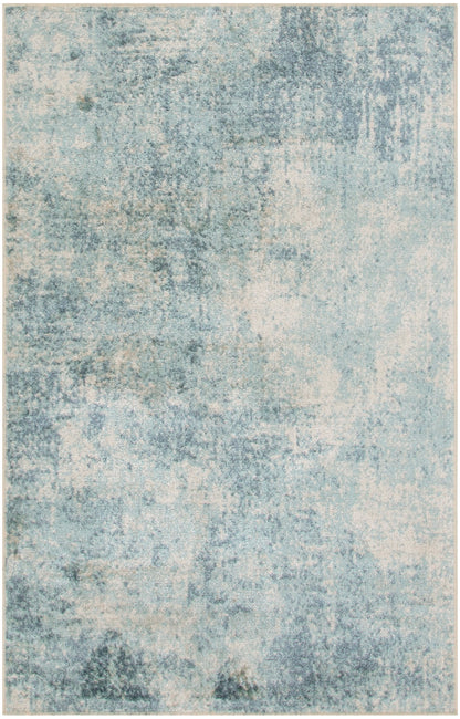 Modern abstract area rug in muted blue & cream with distressed, washed textures.