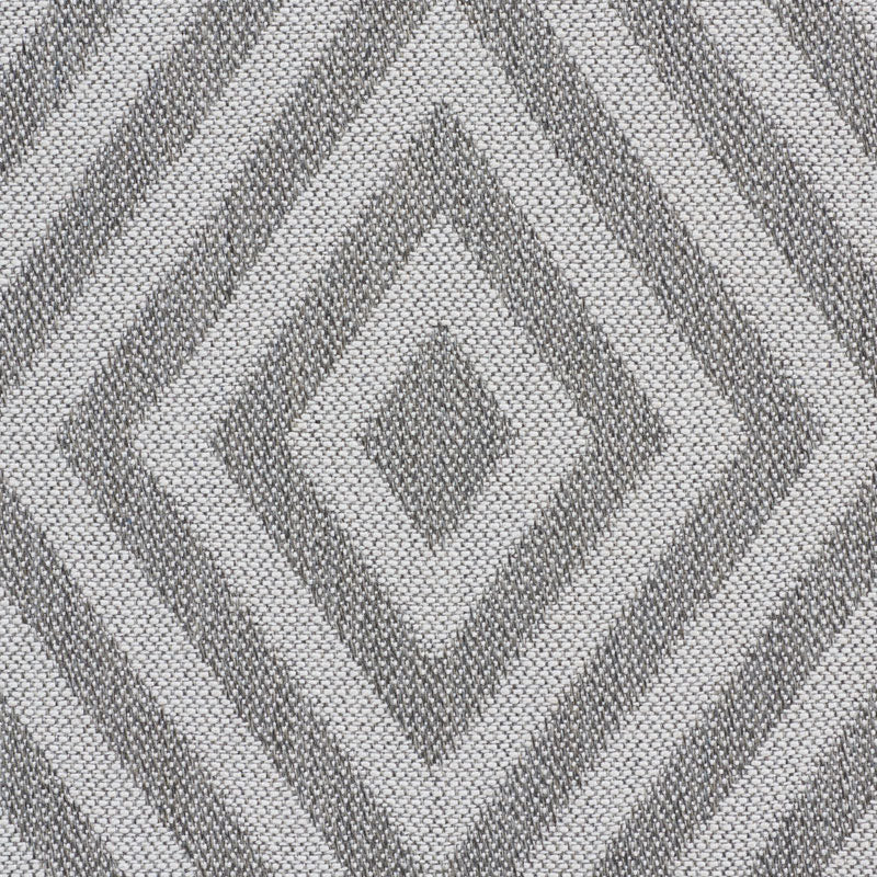 Chevron-patterned fabric strip in white & blue beside a solid gray panel; textile texture suggests upholstery or garment.