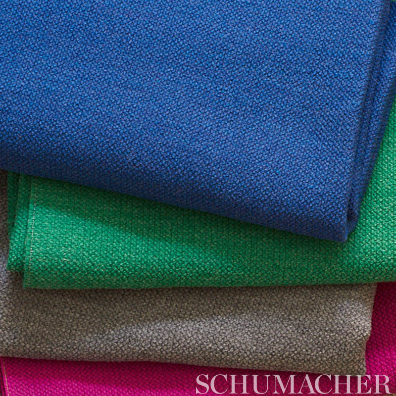Stacked textured fabric swatches in blue, green, beige and magenta with a visible coarse weave.