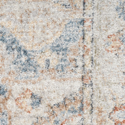 Close-up of a beige distressed area rug with blue and rust floral motifs and soft plush pile.