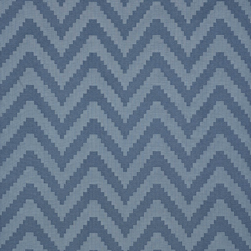 Indigo patterned woven fabric swatch with a solid light-blue area on a blue chevron backdrop; smooth rectangular piece.