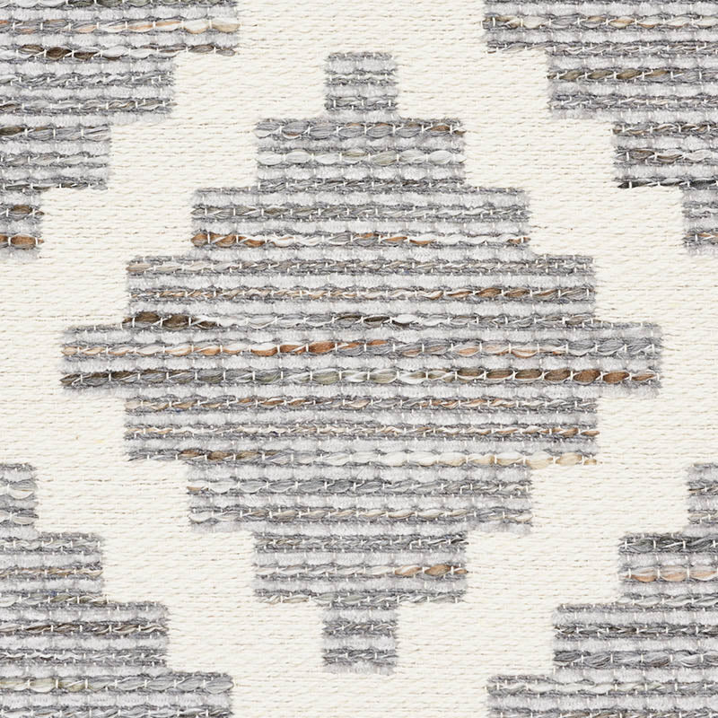 Grey woven rug with geometric diamond pattern; textured, contemporary tribal style.