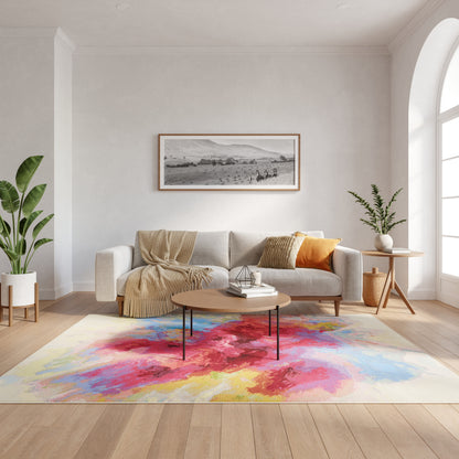 Cozy living room with beige sofa, colorful abstract rug, round wood coffee table, framed art & potted plants.