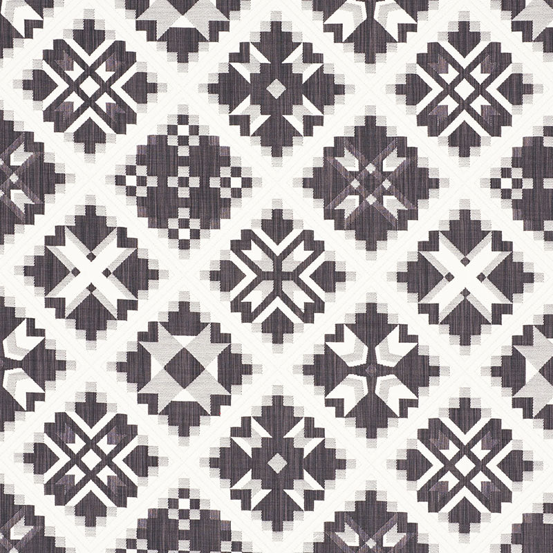 Gray geometric quilt-pattern fabric with white and dark gray diamonds and star motifs in a diamond grid.