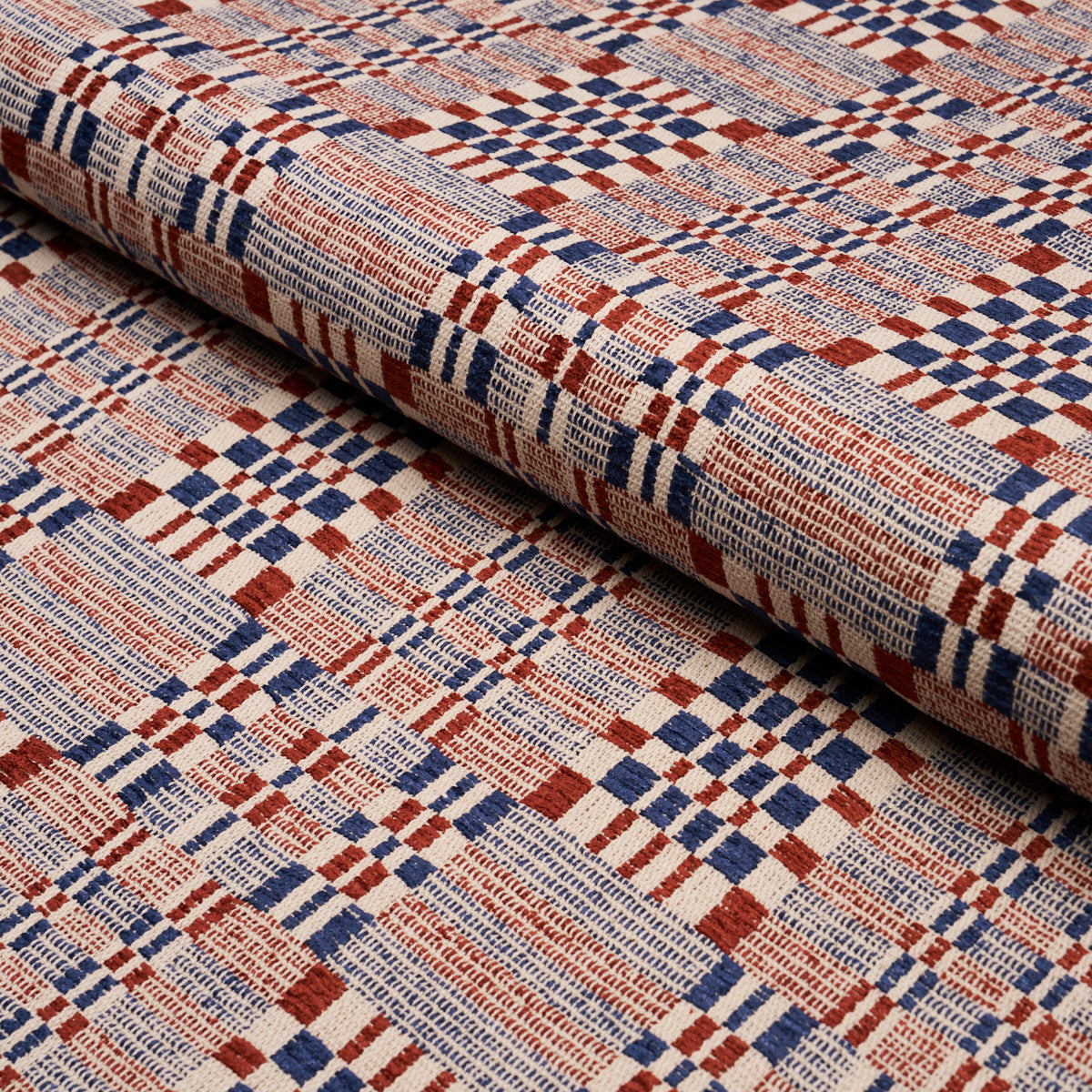 Rolled woven fabric with red, blue and cream plaid pattern; versatile upholstery or craft textile.