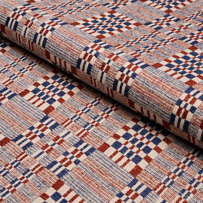Rolled woven fabric with red, blue and cream plaid pattern; versatile upholstery or craft textile.