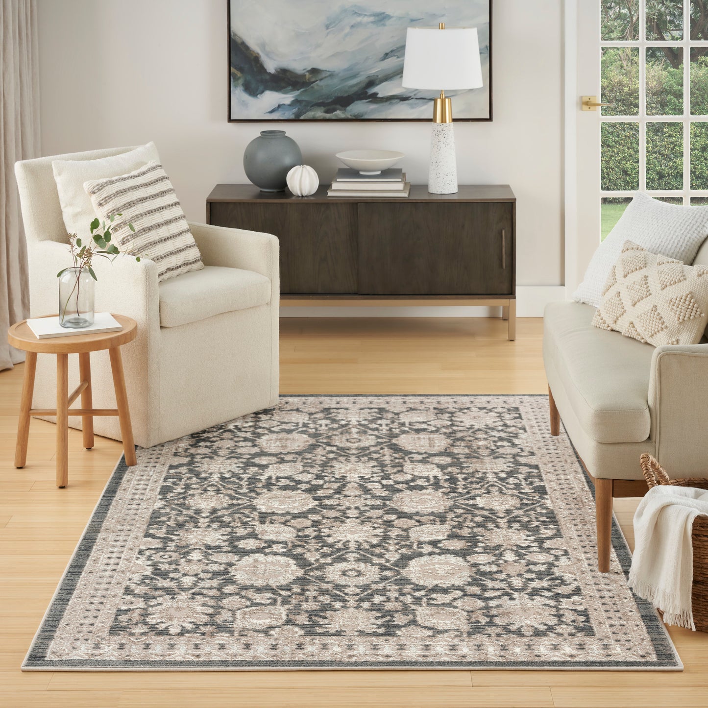 Traditional-inspired woven area rug in ivory, taupe and charcoal with floral medallion border, ideal for living room.