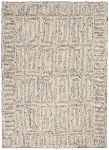Beige and cream rug with blue-gray geometric pattern of stacked rectangles and border, soft textured pile.