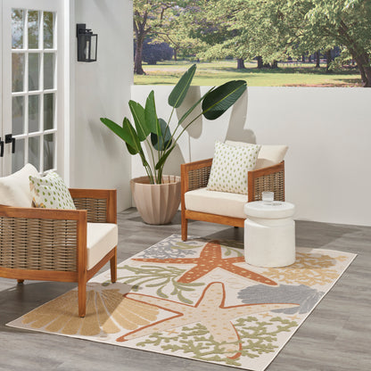 Outdoor seating with two wicker armchairs, white cushions, starfish rug, and large leafy plant.
