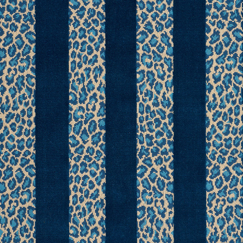 Navy blue vertical stripes between beige-blue leopard-print panels on woven fabric.