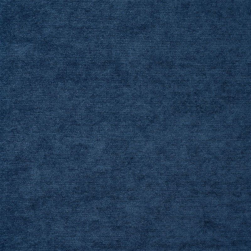 Dark indigo chenille fabric texture with soft pile for apparel or upholstery.
