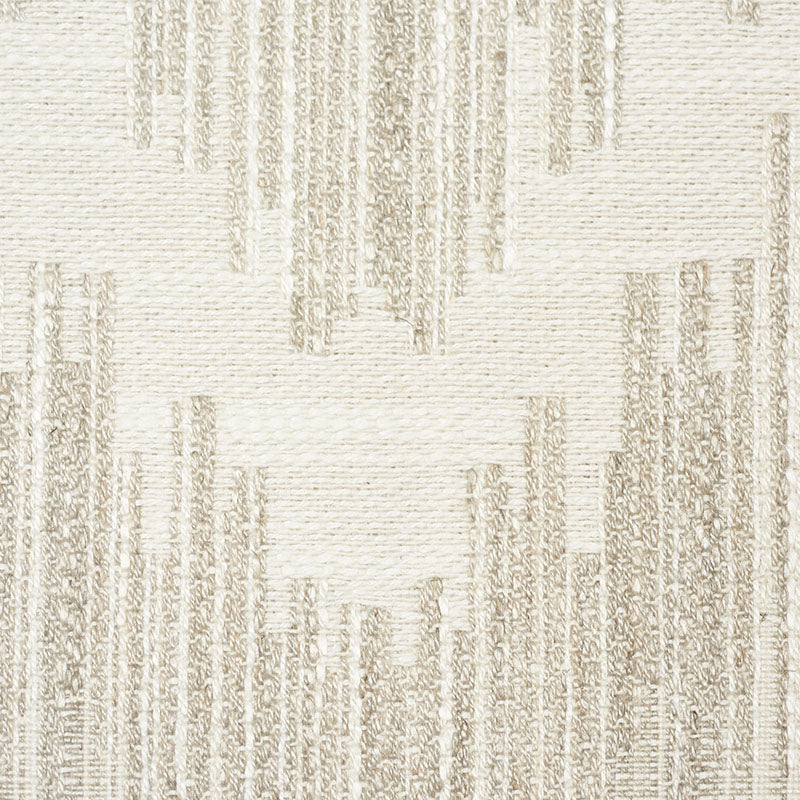 Beige and cream geometric woven rug with vertical column motifs and textured surface.