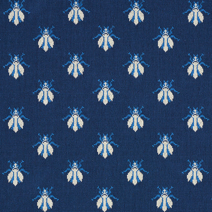 Navy blue textile with small white and light-blue bees repeating; vintage woven pattern for upholstery or apparel.