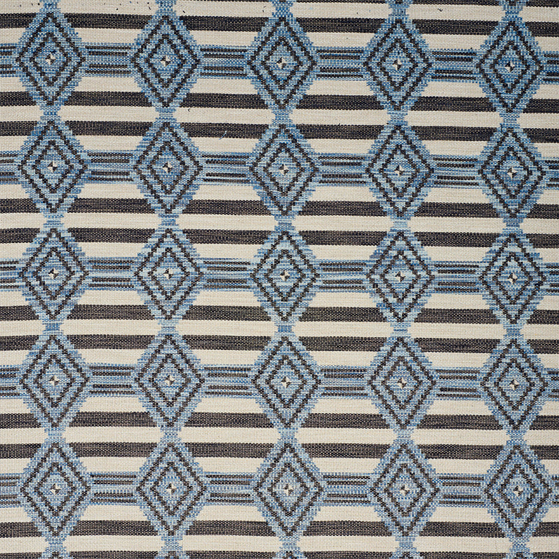 Blue diamond lattice pattern on tan background with narrow black stripes; woven upholstery or drapery fabric.