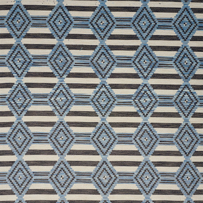 Blue diamond lattice pattern on tan background with narrow black stripes; woven upholstery or drapery fabric.