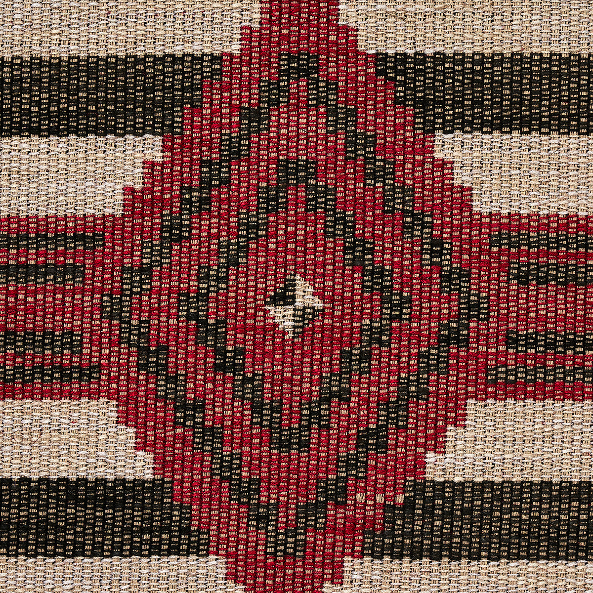 Red diamond kilim pattern with black borders on a beige and black striped background.