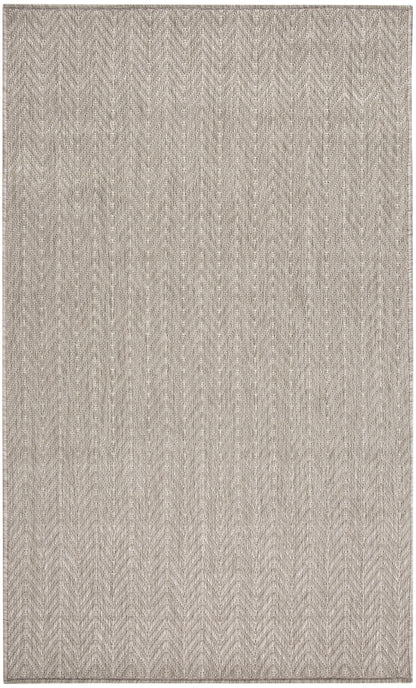Neutral beige chevron rug with subtle woven texture.