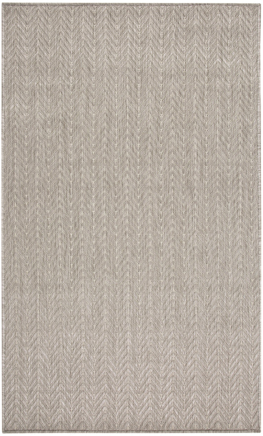 Neutral beige chevron rug with subtle woven texture.