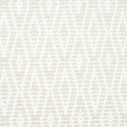 Ivory woven fabric with a raised diamond lattice pattern; soft, textured textile for throws or cushions.