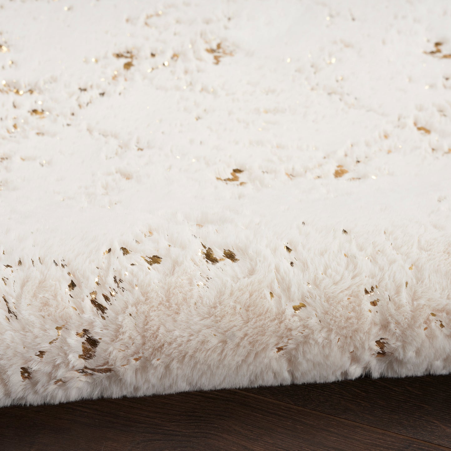 Ivory shag rug with long plush pile on dark wooden floor