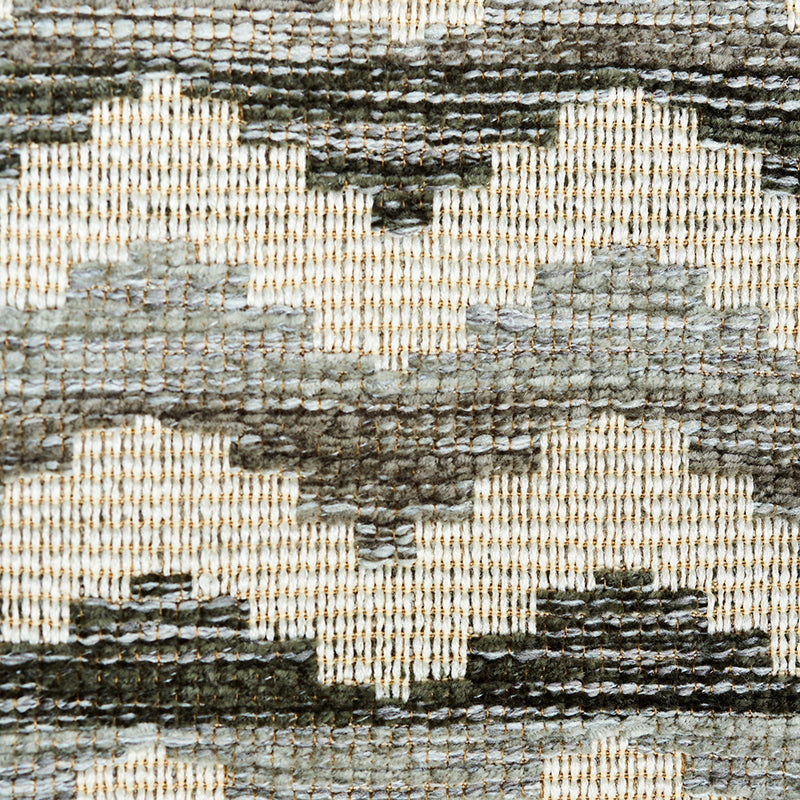 Close-up of a geometric patterned woven rug in gray tones with charcoal accents.