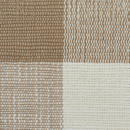 Patterned woven rug with a check design in dark brown, tan, beige, and cream.